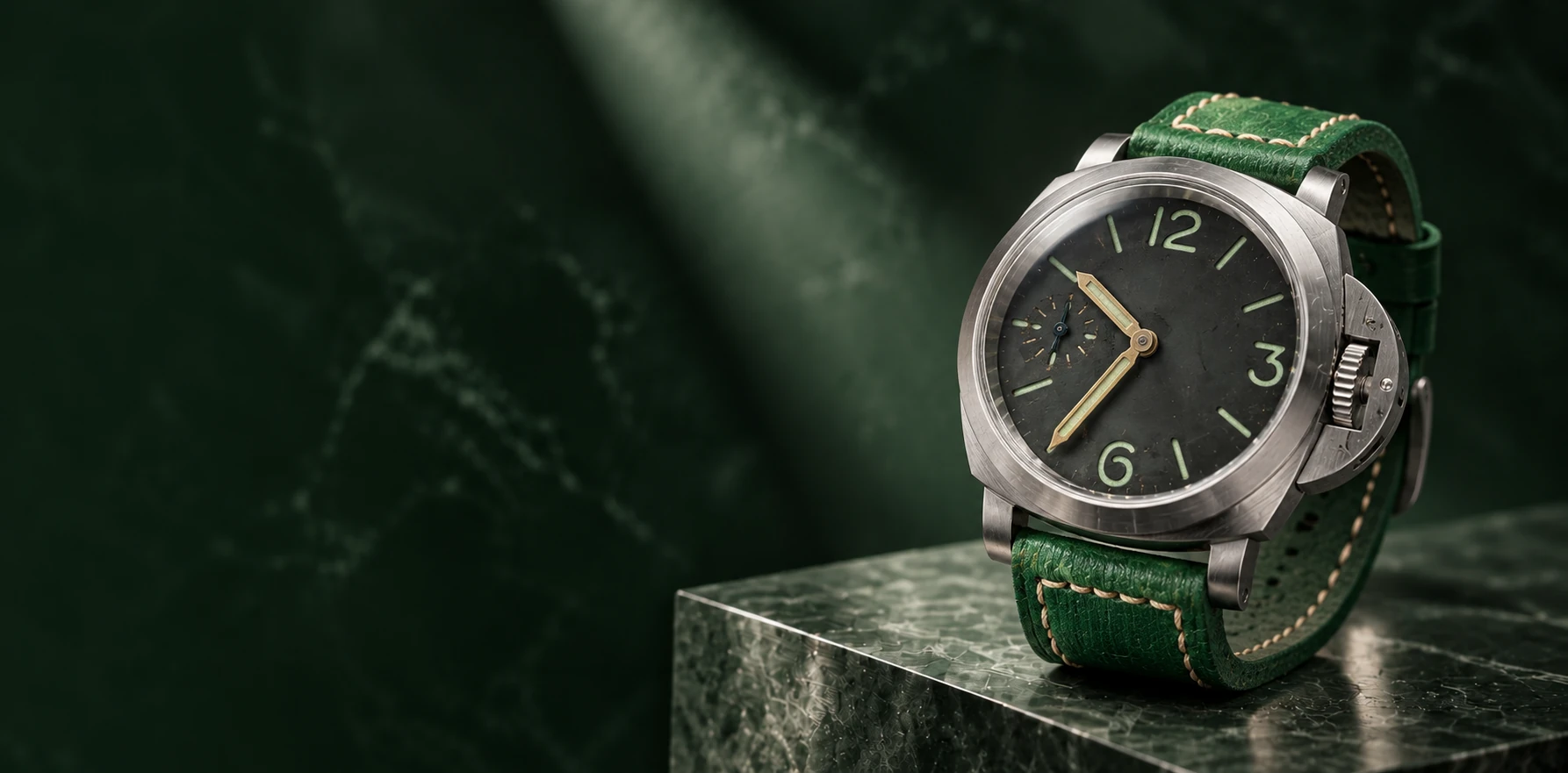 Vanguard, with its patinated dial and green handmade leather strap on forest green stone